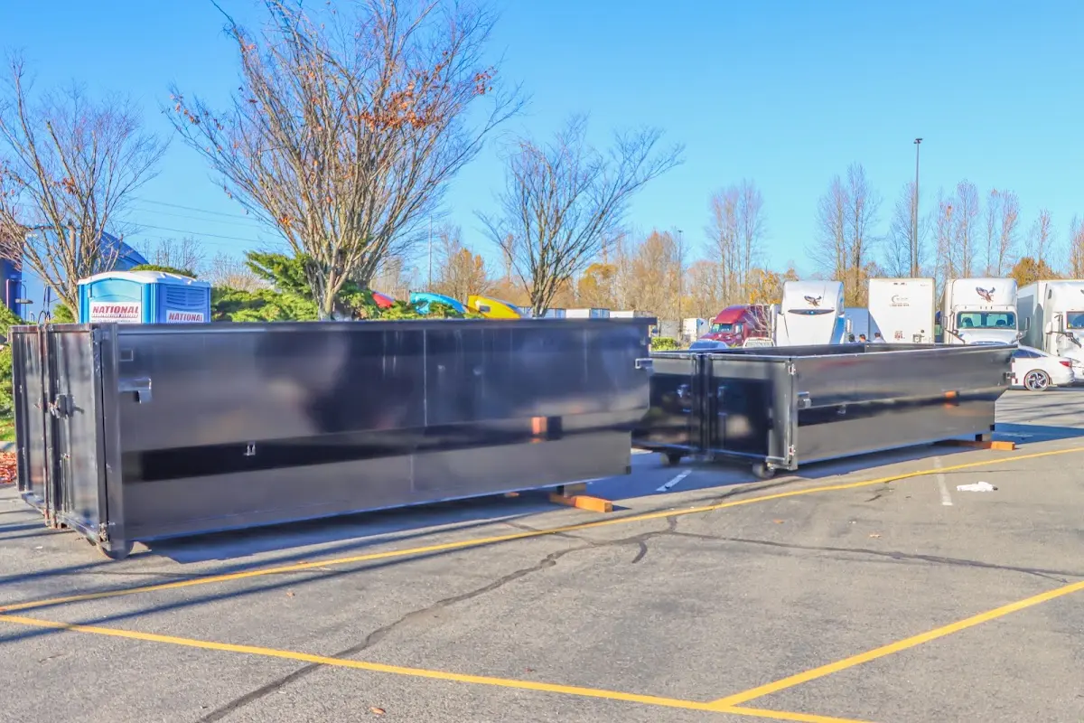 Professional dumpster rental service with roll-off container on residential driveway in Forest Acres